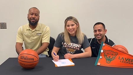 Brianna Morales is joined by assistant coach Justin Marshall (left) and head coach Rene Herrera (right) before signing with the University of La Verne.